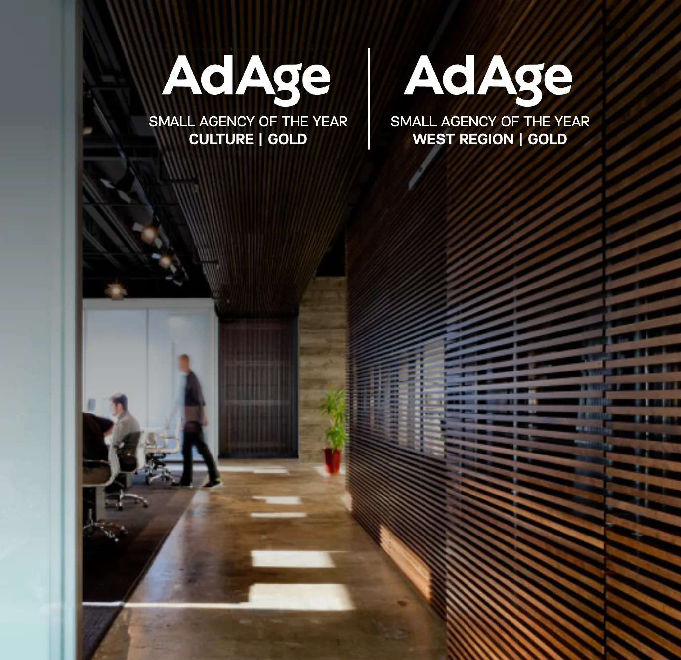Ad Age Small Agency of the Year &mdash; Culture, Gold and West Region, Gold &mdash; over a corridor in the Chapter & Verse office, walled on one side in slatted wood and on the other in frosted glass, opening onto a meeting room where two people are working.